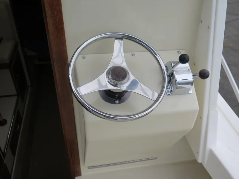 Slide: The Image of Steering wheel and controls of 1988 Blackman 26 Billfisher boat. - 17