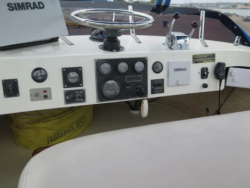 Slide: The Image of 1988 Blackman 26 Billfisher boat dashboard with steering wheel and Simrad equipment. - 18