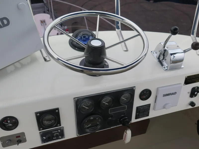 Slide: The Image of Helm of 1988 Blackman 26 Billfisher with steering wheel and control panel. - 23