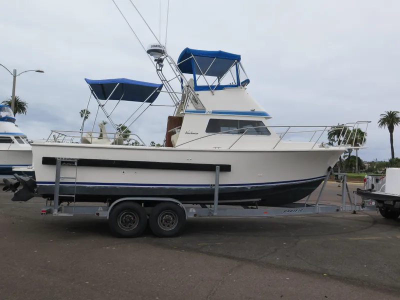 Slide: The Image of 1988 Blackman 26 Billfisher boat on trailer with blue canopy. - 35