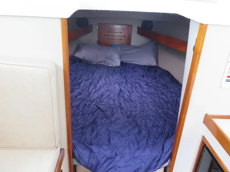 Slide: The Image of Cozy cabin interior of 1988 Blackman 26 Billfisher with blue bedding. - 8