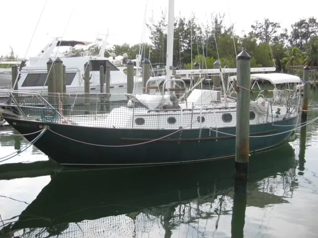 Slide: The Image of 1986 Pacific Seacraft Crealock 34 sailboat docked in a marina. - 0