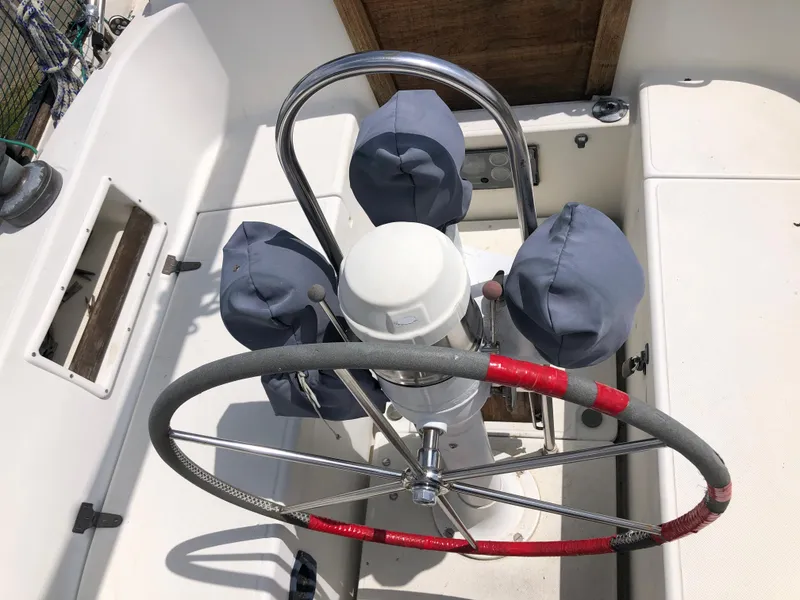 Slide: The Image of 1986 Pacific Seacraft Crealock 34 sailboat cockpit with covered instruments and steering wheel. - 10