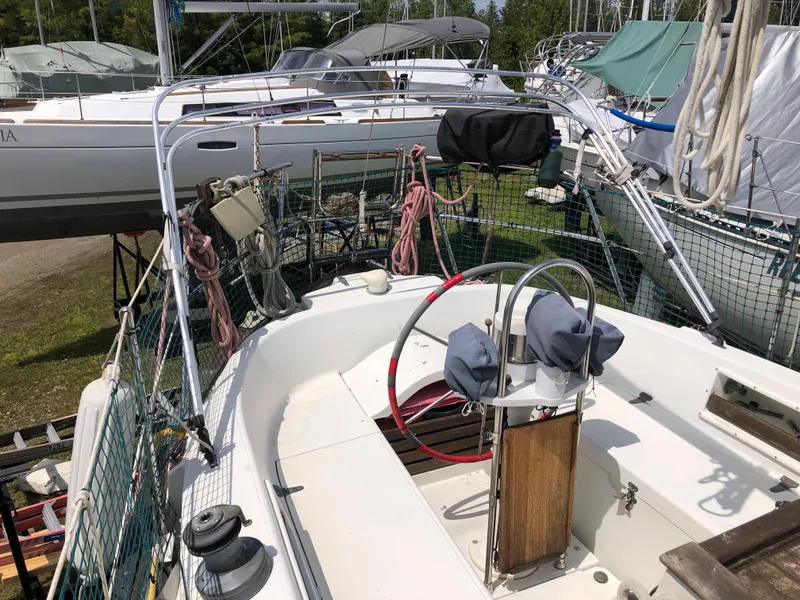 Slide: The Image of 1986 Pacific Seacraft Crealock 34 sailboat cockpit with steering wheel and rigging. - 11