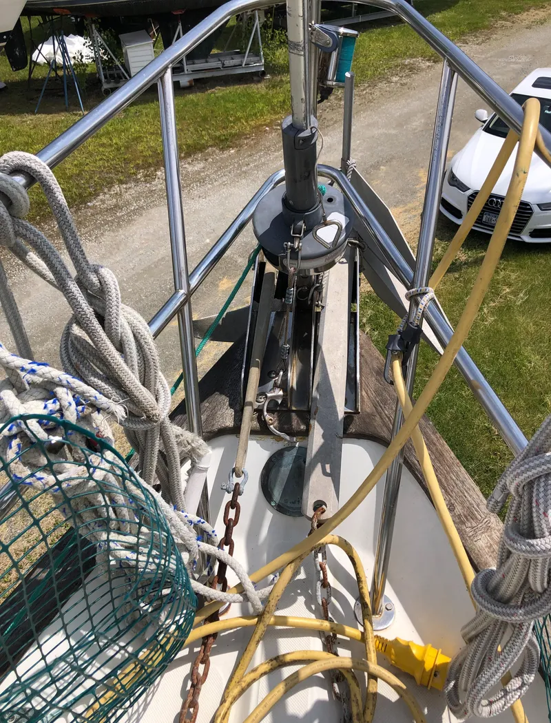 Slide: The Image of 1986 Pacific Seacraft Crealock 34 sailboat deck with ropes and anchor equipment. - 15