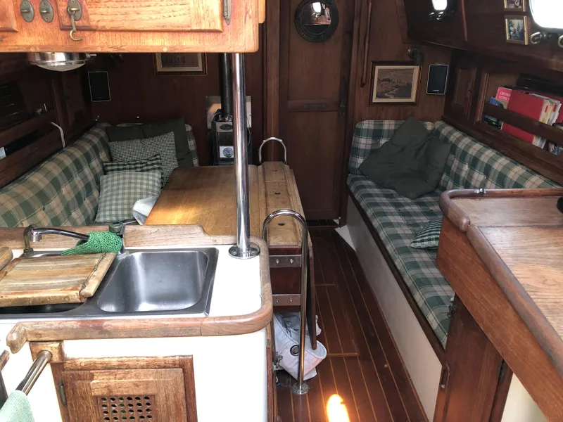 Slide: The Image of Interior of 1986 Pacific Seacraft Crealock 34 sailboat with cozy seating and wooden finishes. - 17