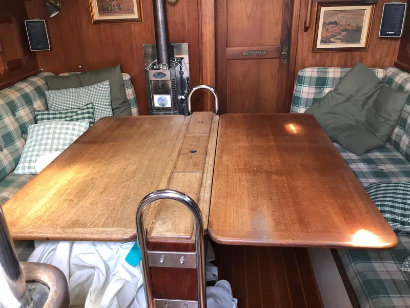 Slide: The Image of Interior of 1986 Pacific Seacraft Crealock 34 with wooden table and plaid seating. - 20