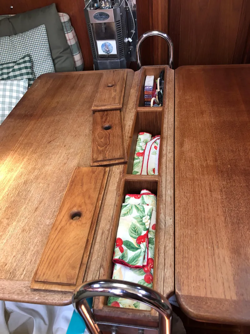 Slide: The Image of Interior of 1986 Pacific Seacraft Crealock 34 with wooden table and storage compartments. - 22