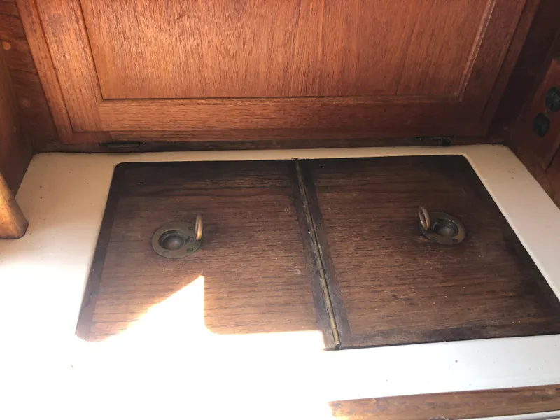 Slide: The Image of Wooden cabinet doors on a 1986 Pacific Seacraft Crealock 34 sailboat interior. - 26