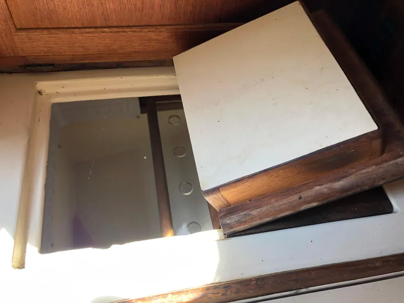 Slide: The Image of Interior detail of 1986 Pacific Seacraft Crealock 34 sailboat, featuring a wooden hatch cover. - 27