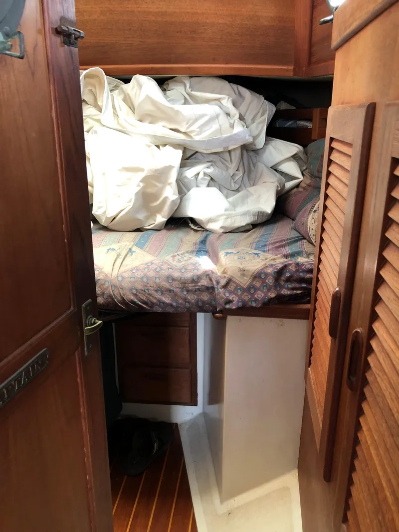 Slide: The Image of 1986 Pacific Seacraft Crealock 34 cabin with bed and stored sails. - 42