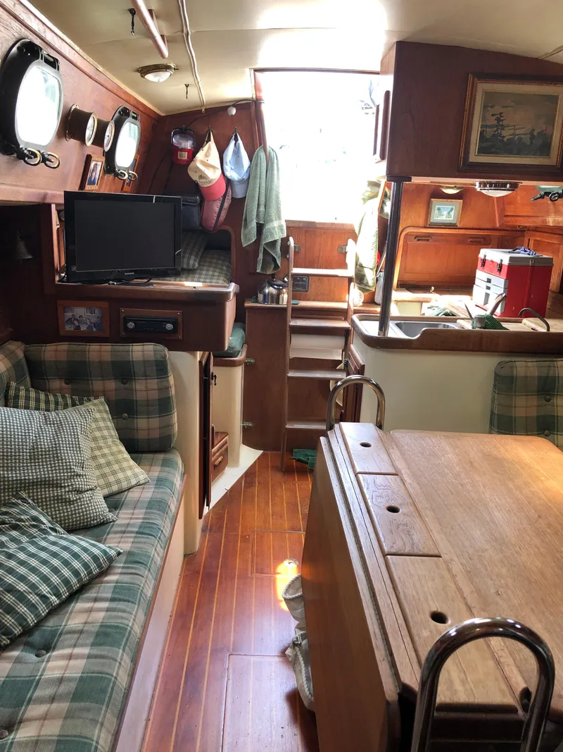 Slide: The Image of Interior of 1986 Pacific Seacraft Crealock 34 sailboat with cozy seating and wooden finishes. - 47