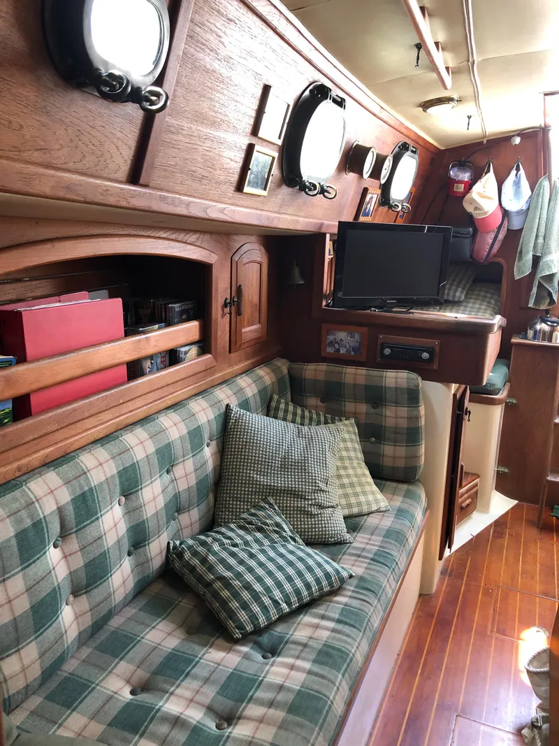 Slide: The Image of Interior of 1986 Pacific Seacraft Crealock 34 sailboat with plaid seating and wooden accents. - 48