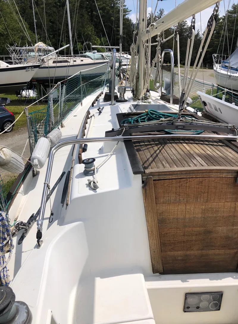 Slide: The Image of 1986 Pacific Seacraft Crealock 34 sailboat deck with wooden hatch and rigging. - 7