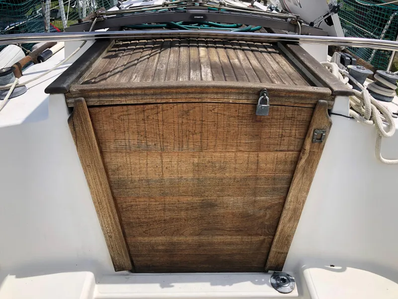 Slide: The Image of 1986 Pacific Seacraft Crealock 34 sailboat with wooden hatch and lock. - 8