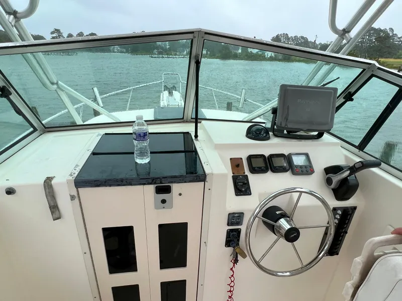 Slide: The Image of Helm of 2006 Parker 2310 Walkaround boat with steering wheel and navigation equipment. - 10