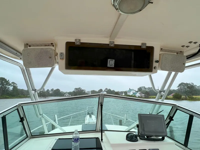 Slide: The Image of Interior view of a 2006 Parker 2310 Walkaround boat with water and shoreline visible. - 11