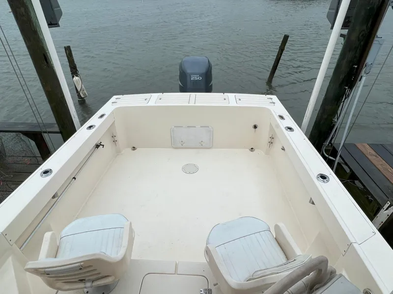 Slide: The Image of 2006 Parker 2310 Walkaround boat deck with seating, overlooking calm water. - 4