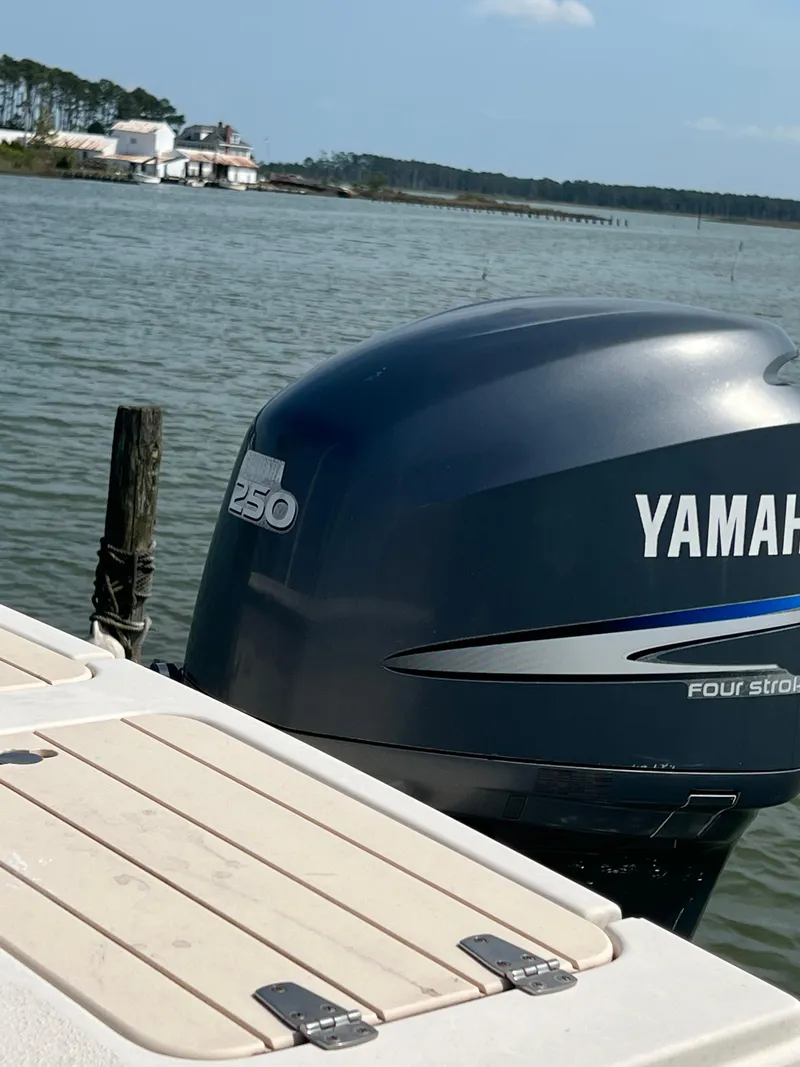 Slide: The Image of Yamaha 250 outboard motor on 2006 Parker 2310 Walkaround boat, scenic waterfront view. - 7