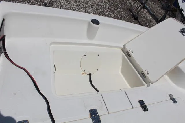 Slide: The Image of 2021 Mako Pro Skiff 15 CC storage compartment with open lid. - 13