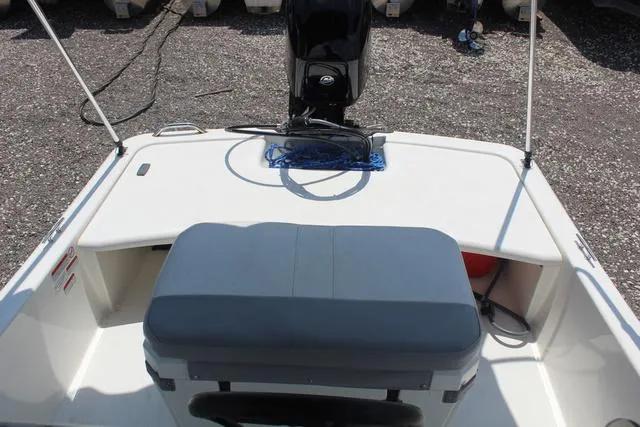 Slide: The Image of Rear view of a 2021 Mako Pro Skiff 15 CC with motor. - 18