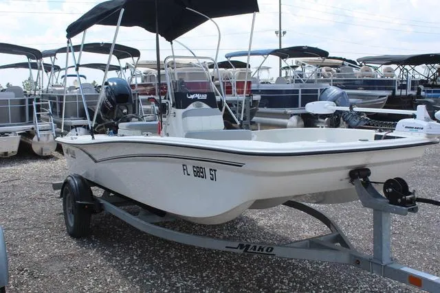 Slide: The Image of 2021 Mako Pro Skiff 15 CC boat on trailer outdoors. - 3