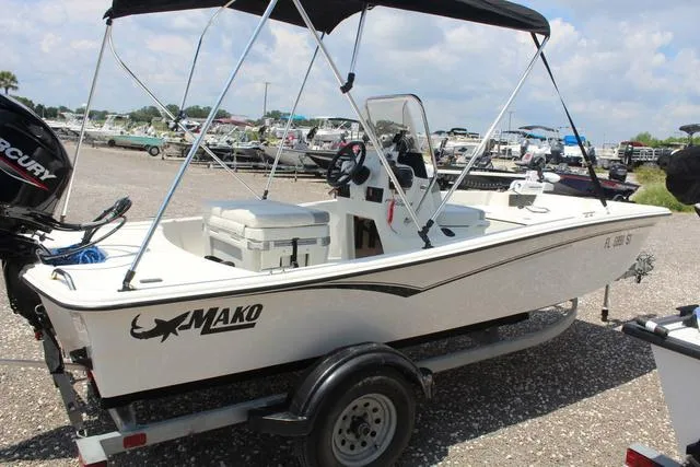 Slide: The Image of 2021 Mako Pro Skiff 15 CC boat on trailer outdoors. - 4