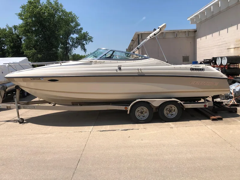 The Image of 1997 Ebbtide 2300 Cuddy boat on trailer, parked outdoors. - 0