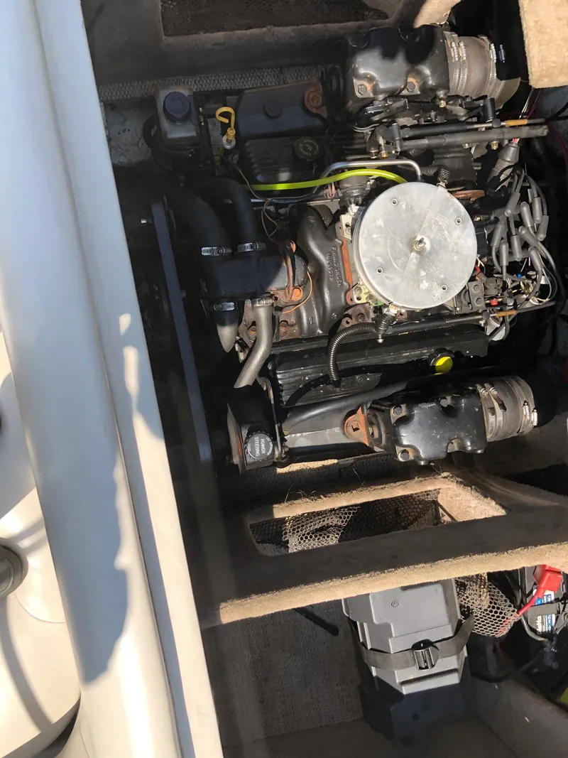 Slide: The Image of 1997 Ebbtide 2300 Cuddy boat engine compartment with visible components. - 12