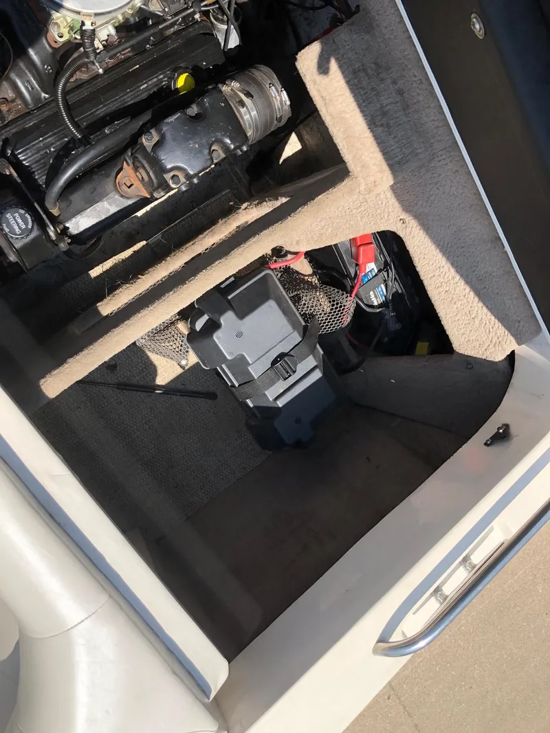 Slide: The Image of 1997 Ebbtide 2300 Cuddy boat engine compartment with visible components. - 13