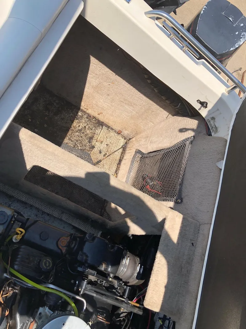 Slide: The Image of 1997 Ebbtide 2300 Cuddy boat interior with engine compartment and storage area. - 14