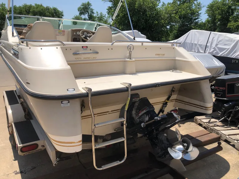 Slide: The Image of 1997 Ebbtide 2300 Cuddy boat, rear view with outboard motor and ladder. - 15