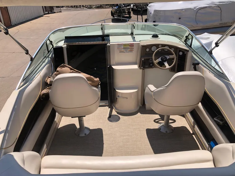 Slide: The Image of 1997 Ebbtide 2300 Cuddy boat interior with steering wheel and seating. - 16