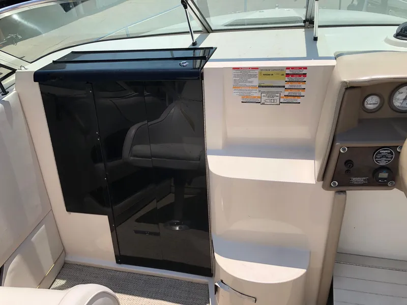 Slide: The Image of 1997 Ebbtide 2300 Cuddy boat interior with dashboard and seating area. - 17