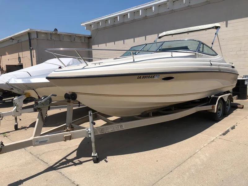 Slide: The Image of 1997 Ebbtide 2300 Cuddy boat on trailer, parked outdoors. - 2