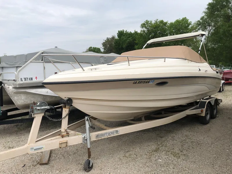 Slide: The Image of 1997 Ebbtide 2300 Cuddy boat on trailer, parked outdoors. - 3