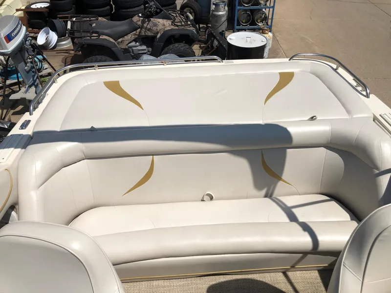 Slide: The Image of 1997 Ebbtide 2300 Cuddy boat interior with white cushioned seating. - 9