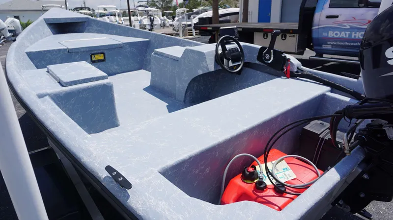 Slide: The Image of 2023 Griffis Fiberglass 16 Wide Side Console boat with outboard motor and fuel tank. - 3