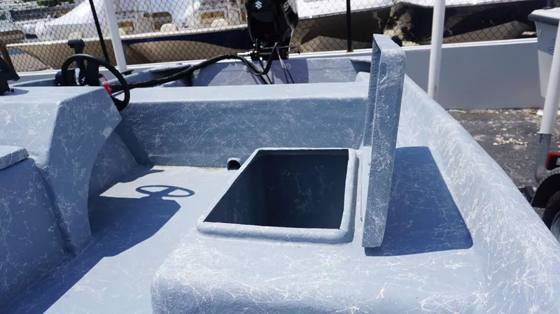 Slide: The Image of 2023 Griffis Fiberglass 16 Wide Side Console boat interior with open storage compartment. - 9