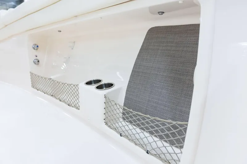 Slide: The Image of 2024 Grady-White Canyon 386 interior storage with cup holders and netting. - 13