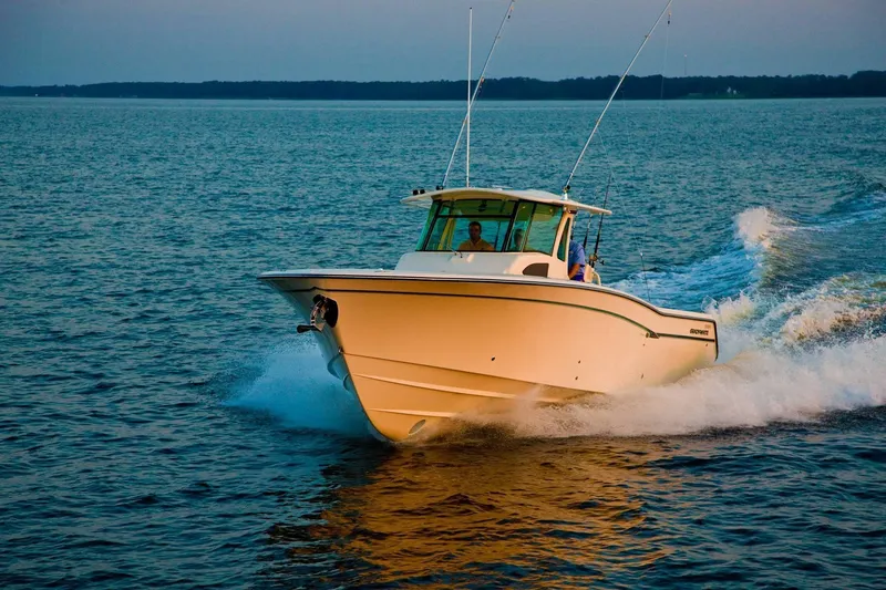 Slide: The Image of 2024 Grady-White Canyon 386 boat cruising on open water. - 2