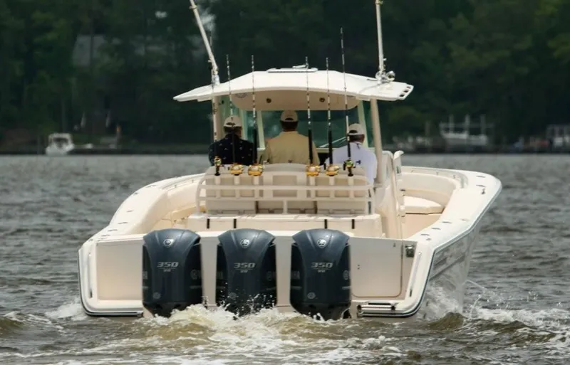 Slide: The Image of 2024 Grady-White Canyon 386 boat with triple Yamaha 350 engines on water. - 3