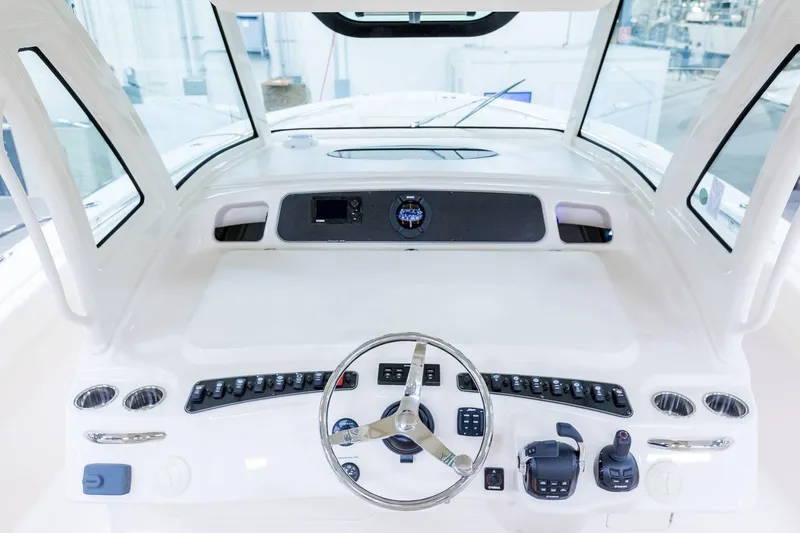 Slide: The Image of 2024 Grady-White Canyon 386 helm station with steering wheel and control panel. - 5
