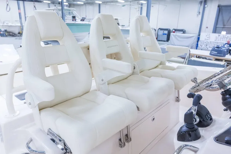 Slide: The Image of 2024 Grady-White Canyon 386 boat interior with luxurious white captain's chairs. - 9