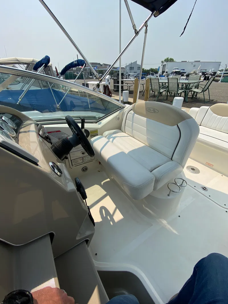 Slide: The Image of 2008 Sea Ray 240 Sundancer boat interior with helm and seating area. - 10