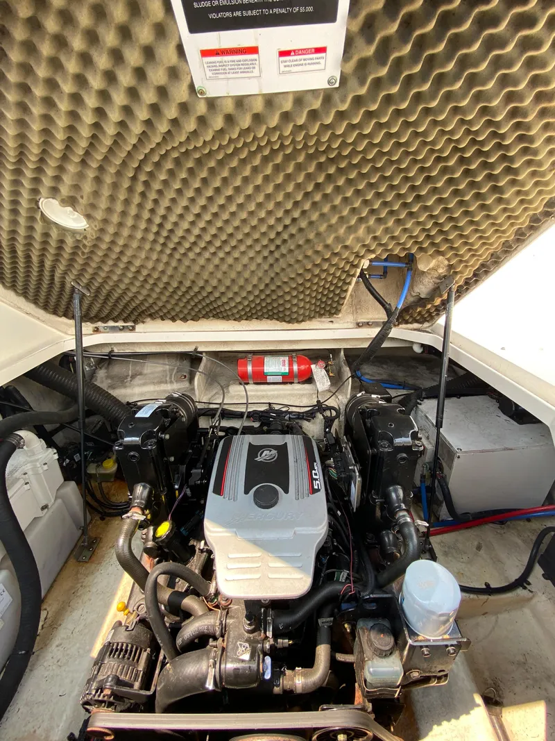 Slide: The Image of Engine compartment of a 2008 Sea Ray 240 Sundancer boat, showcasing the motor and components. - 16