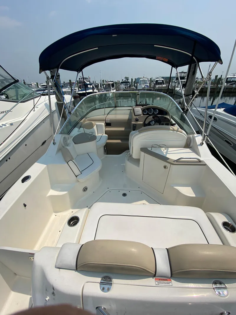 Slide: The Image of 2008 Sea Ray 240 Sundancer boat with canopy, docked at marina. - 5