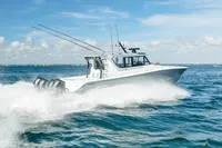 Slide: The Image of 2023 Invincible 46' Catamaran Pilothouse cruising on open water. - 2