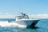 Slide: The Image of 2023 Invincible 46' Catamaran Pilothouse cruising on open water. - 3