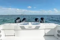 Slide: The Image of 2023 Invincible 46' Catamaran Pilothouse on open water, featuring powerful outboard engines. - 4